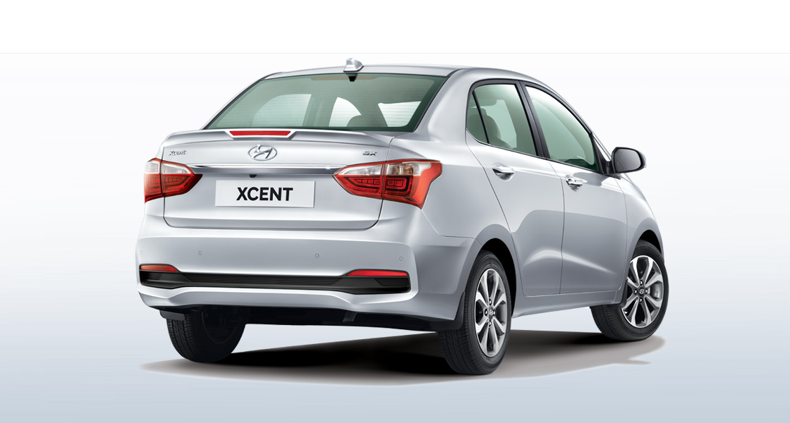 Side rear view of silver Xcent